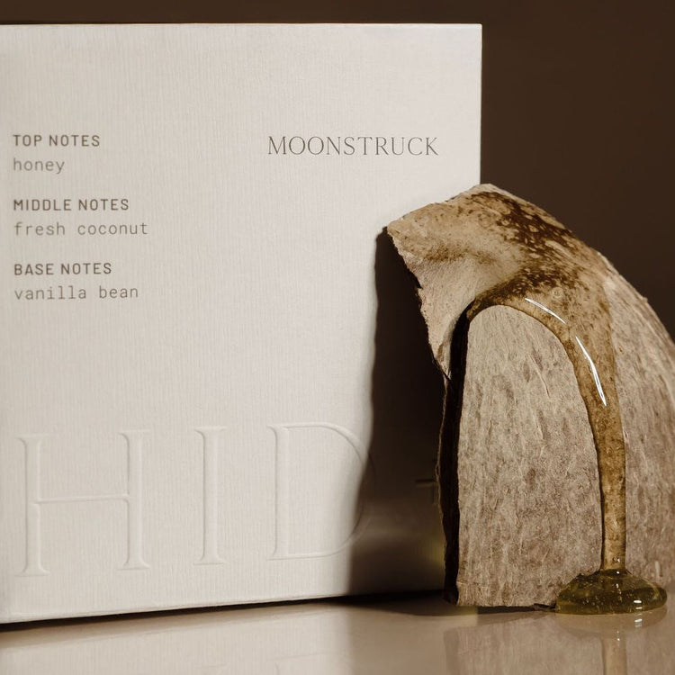 Moonstruck product packaging with a stone-like design on a reflective surface.