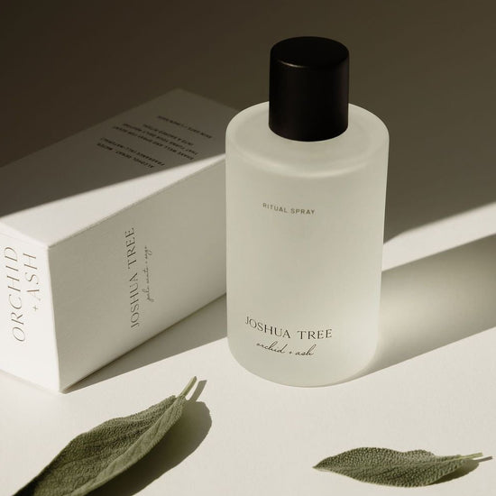 White bottle with black cap labeled &