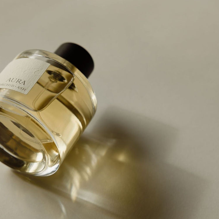 Perfume bottle with a label on a neutral background