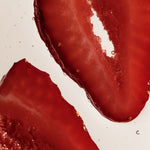 Close-up of two sliced red strawberries on a plain white background.