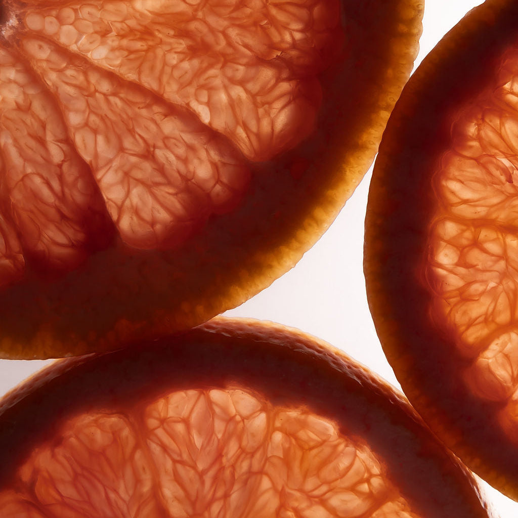 Close-up of sliced grapefruits with a white background