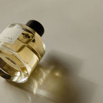 Perfume bottle with a label on a neutral background