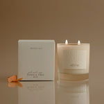 Candle and packaging with 'Joshua Tree' branding on a reflective surface.
