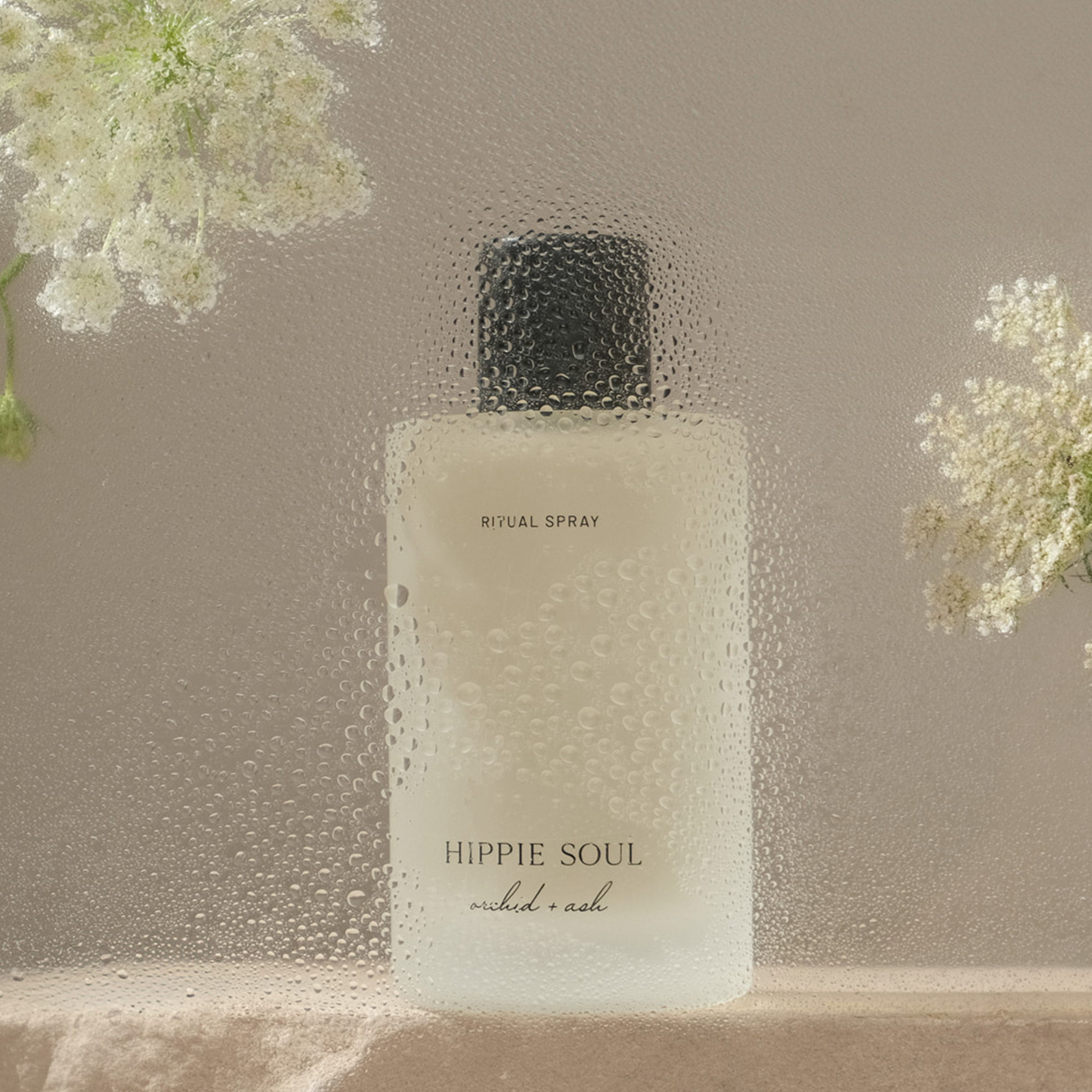 Hippie Soul product bottle with flowers on a neutral background